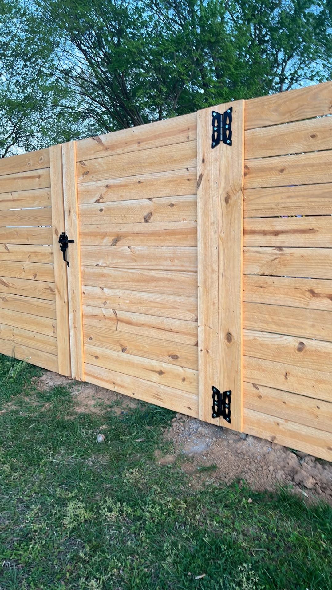Custom horizontal wood fence with gate built by Integrity Fence in Jackson TN