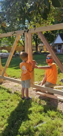 Mike Spencer building a wood structure with his son in Jackson, TN